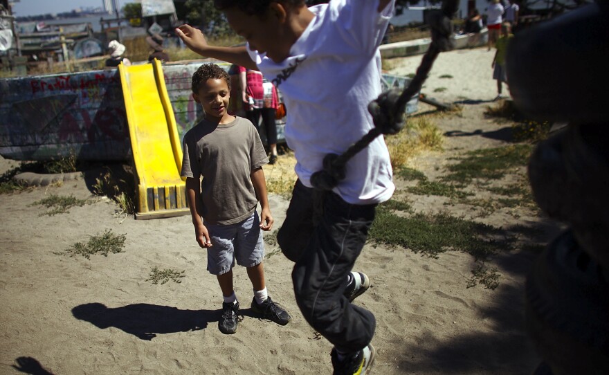 Deion Jefferson, 10, and Samuel Jefferson, 7, take turns climbing and jumping off a stack of old tires at the Berkeley Adventure Playground in California. The playground is a half-acre park with a junkyard feel where kids are encouraged to "play wild."