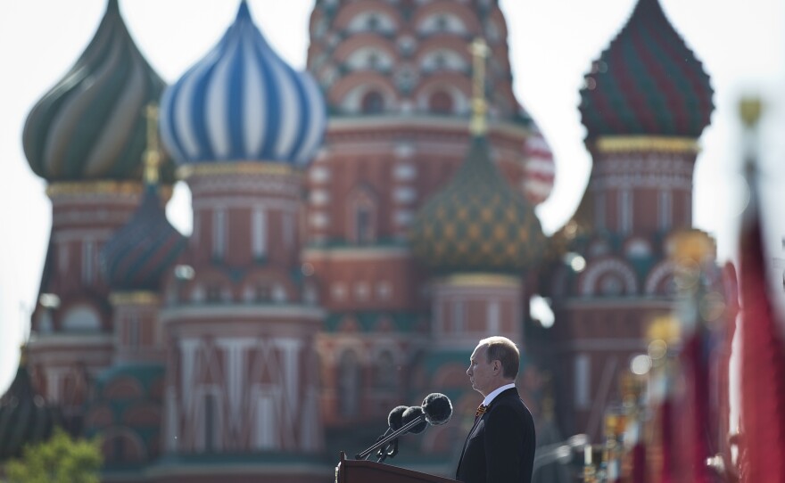 Russian President Vladimir Putin speaks during a Victory Day parade, which commemorates the 1945 defeat of Nazi Germany, with St. Basil's Cathedral in the background.