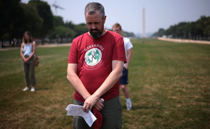 Participants bow their heads in prayer during a COVID-19 prayer vigil on the National Mall honoring and mourning those who have died due to the coronavirus pandemic in Washington, D.C., in July.