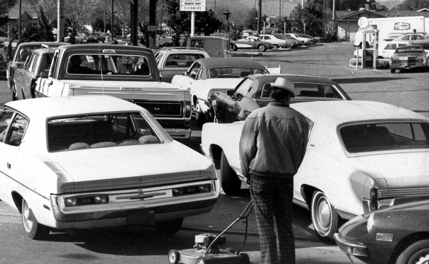 Drivers and a man pushing a lawnmower line up at a gas station in San Jose, Calif., on March 15, 1974. The Arab oil embargo of the era led to supply shortages, lines at gas stations and prices at the pump roughly doubling.