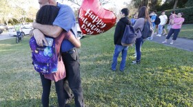 Family member embrace following a shooting at Marjory Stoneman Douglas High School, Wednesday, Feb. 14, 2018, in Parkland, Fla. 