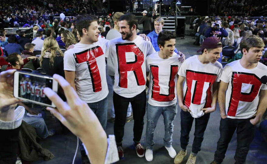 Liberty University students, left to right, Austin Miller, James Ford, Jeremy Boyd, Josiah O'Boyle and Cody Hildebrand wear 'TRUMP' shirts while waiting to hear the Republican presidential candidate.