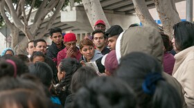A crowd of asylum seekers gather around a waitlist for entering the U.S. through Tijuana, Mexico, Oct. 25, 2018. 
