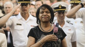 An audience member stands for the national anthem at a previous broadcast of the National Memorial Day Concert.