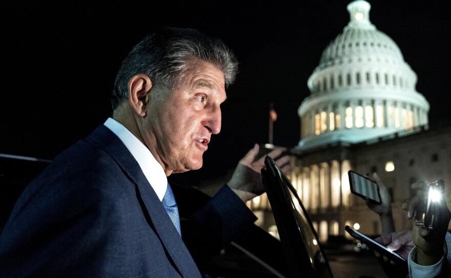 Sen. Joe Manchin, a Democrat from West Virginia, speaks to members of the media while departing the U.S. Capitol on Oct. 7. Manchin has reportedly told the White House that he opposes the key climate measure in Biden's multitrillion-dollar climate and social programs package.
