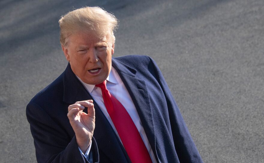 President Trump speaks as he leaves the White House for meetings at Camp David on Sunday. Trump stood firm on his demand for billions of dollars to fund a border wall with Mexico, which has forced a shutdown of the government now entering its third week.