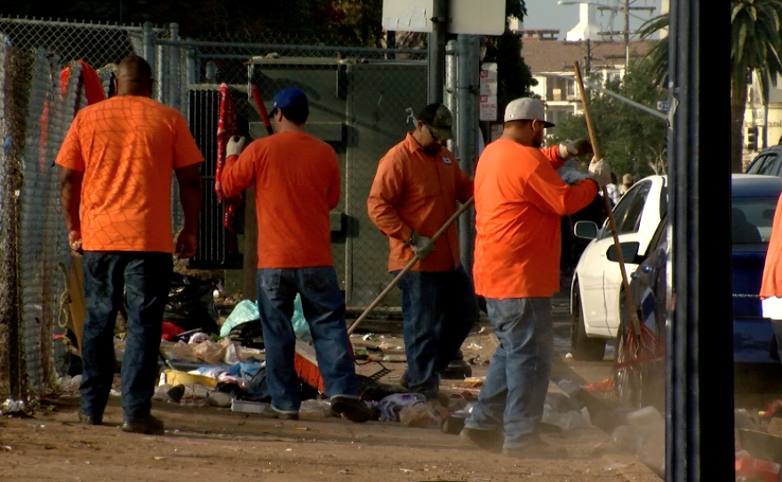 Cleanup crews work to clear the streets of debris downtown, June 23, 2017.