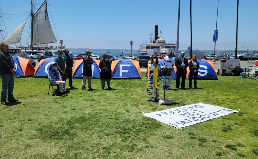 Coleen Cusack, a lawyer with the San Diego Emergency Housing Alliance, addresses the media at Waterfront Park on June 16, 2022.