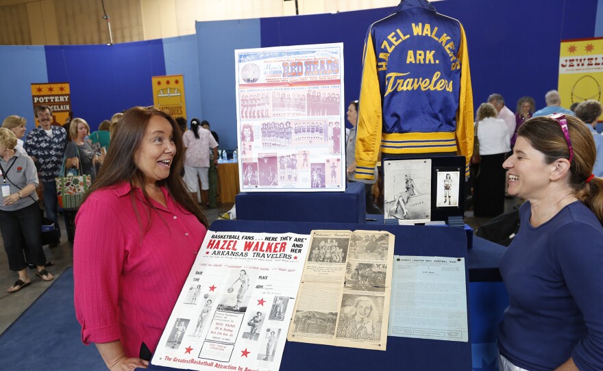 Leila Dunbar (right) appraises a women’s pro basketball collection, in Baton Rouge, La. ANTIQUES ROADSHOW “Never Seen That Before!” airs Monday, May 12 at 8/7C PM on PBS.
