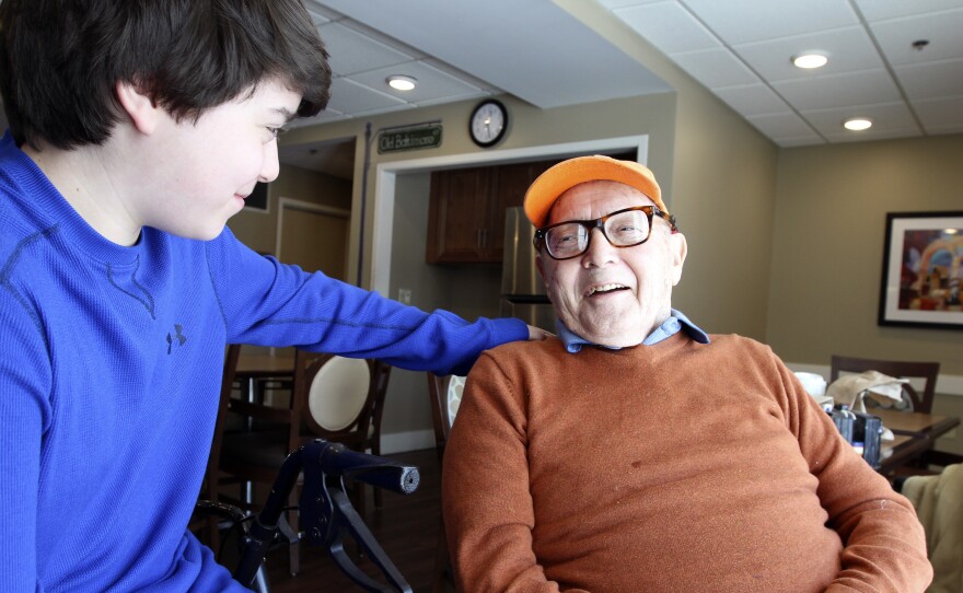 Paul Miller shares a joke with his grandson, Max. They play poker together, but as a numbers guy, Miller is hard to beat.