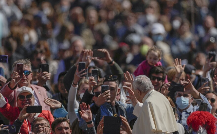 Pope Francis on his popemobile drives through the crowd of faithful at the end of the Catholic Easter Sunday mass he led in St. Peter's Square at the Vatican, Sunday, April 17, 2022.