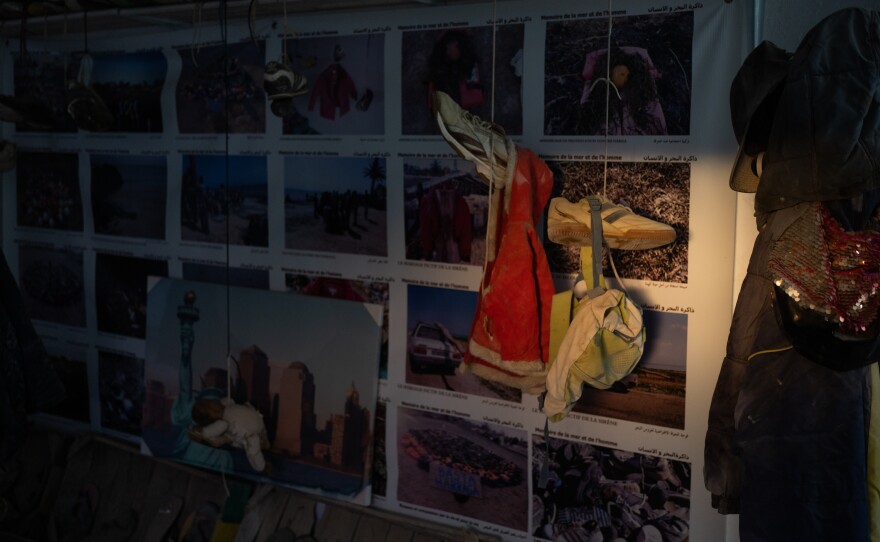 A little girl's red coat hangs in the museum.