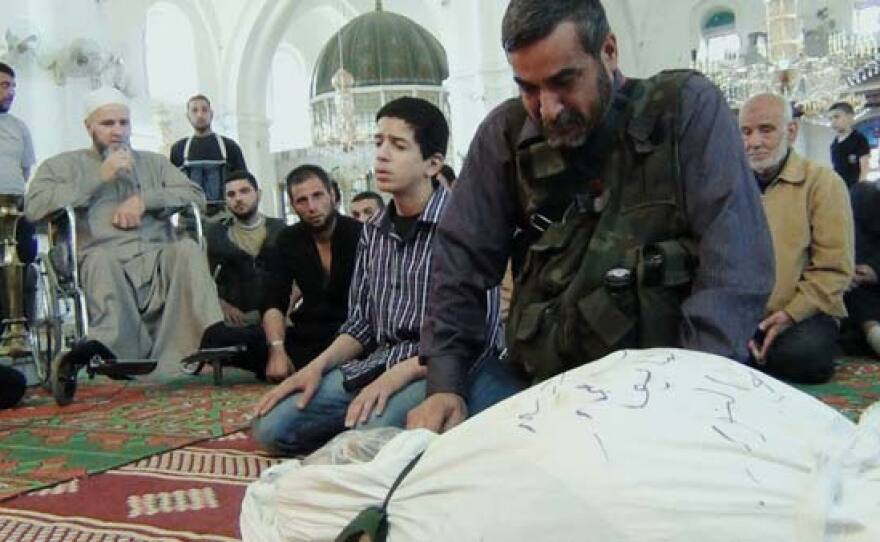 FSA rebels mourn a fallen fighter inside the beseiged city.