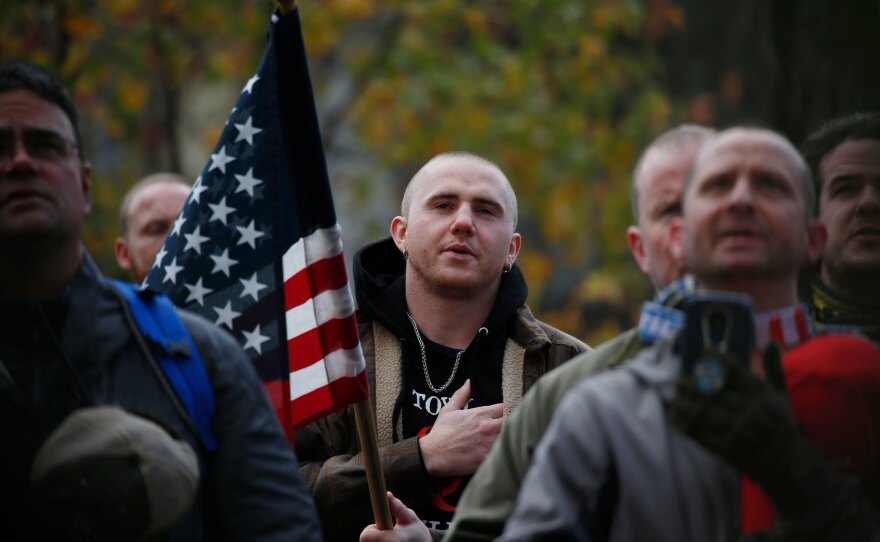 Attendees recite the Pledge of Allegiance during the United Against Hate rally by the Washington Three Percent in Seattle last month.