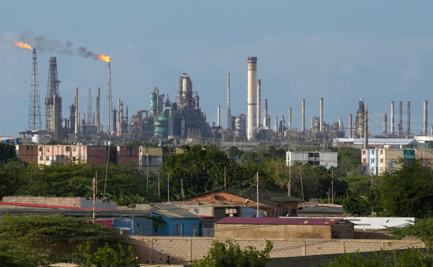 FILE - Flames rise from flare stacks at the Amuay refinery in Los Taques, Venezuela, Jan. 14, 2026.