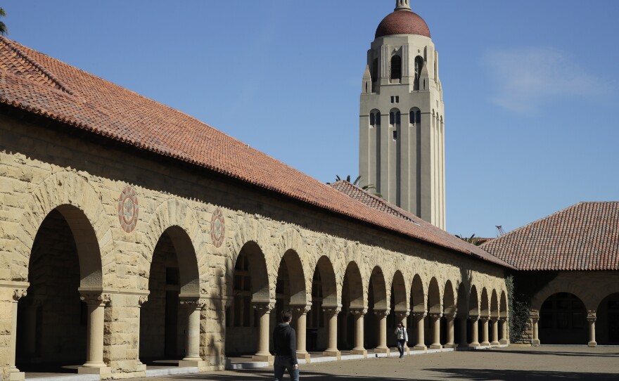 People walk on the Stanford University campus beneath Hoover Tower in Stanford, Calif., on March 14, 2019. Stanford President Marc Tessier-Lavigne said on Wednesday he would resign, citing an independent review that cleared him of research misconduct but found flaws in other papers authored by his lab.