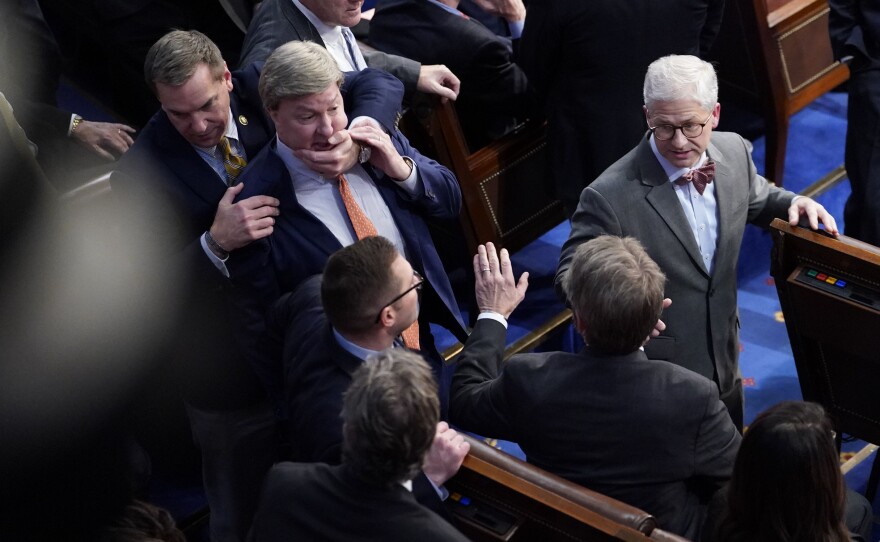 Rep. Mike Rogers (R-AL) is restrained after getting into an argument with Rep. Matt Gaetz (R-FL) during in the 14th round of voting for speaker.