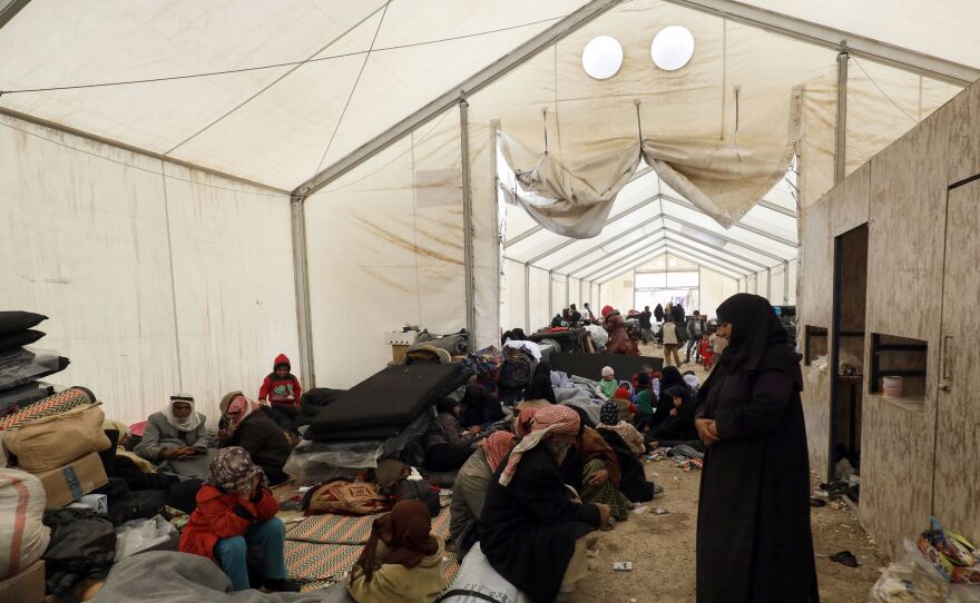 Displaced Syrians gather inside a tent in the Al-Hol camp in northeastern Syria in December.