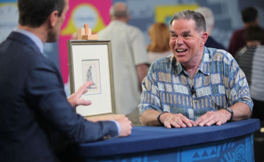Todd Weyman (left) appraises a Rembrandt etching, ca. 1630 in Omaha, Neb.
