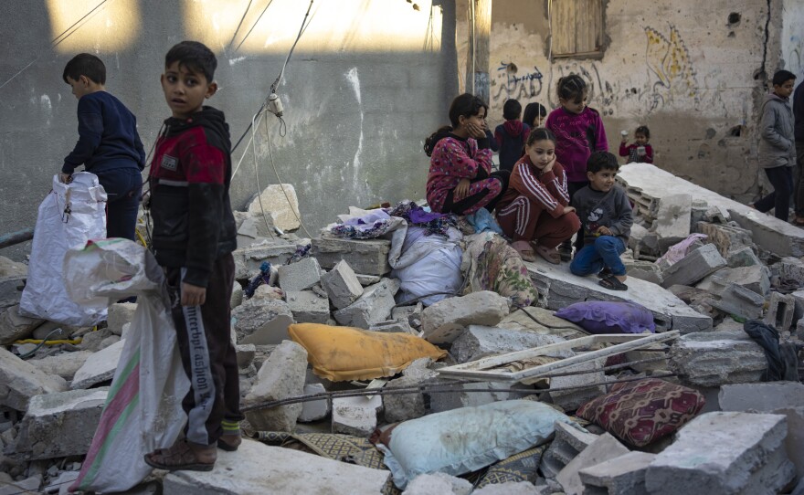 Palestinian children look at the destruction after an Israeli strike in Rafah, in southern Gaza, on Dec. 29.