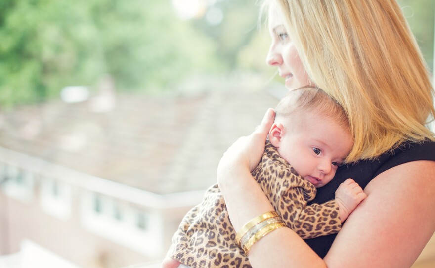 Lisa Abramson holds her firstborn child, Lucy, in 2014. A few weeks after Lucy's birth, Abramson began feeling confused and then started developing delusions — symptoms of postpartum psychosis.