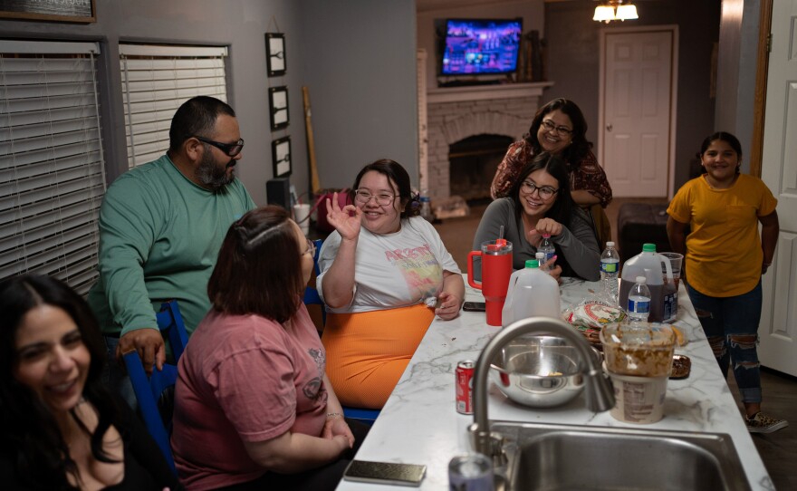 Caitlynn Almance, in the orange skirt, talks with family members at her parents' home in Odessa, Texas.