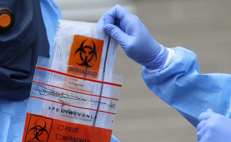 A COVID-19 test is collected in Salt Lake City, Utah. A federal study published Monday found that Hispanic and non-white workers make up a disproportionate share of COVID-19 cases associated with workplace outbreaks in Utah.