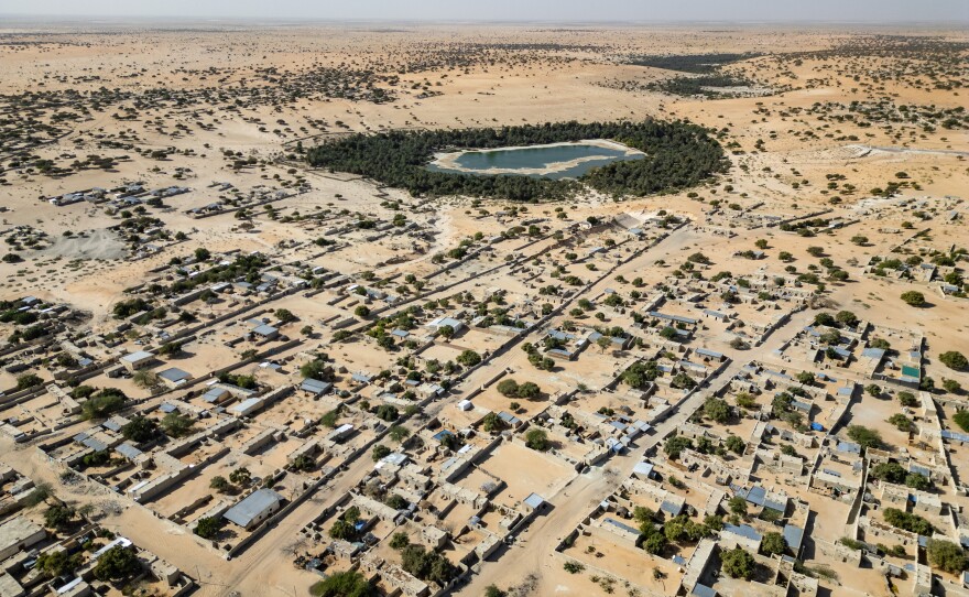 An aerial view of the town of Mao and its oasis in Kanem province, Chad. Such oases feed farmable land for nearby communities — but hotter temperatures and stronger winds are taking a toll, say community elders.