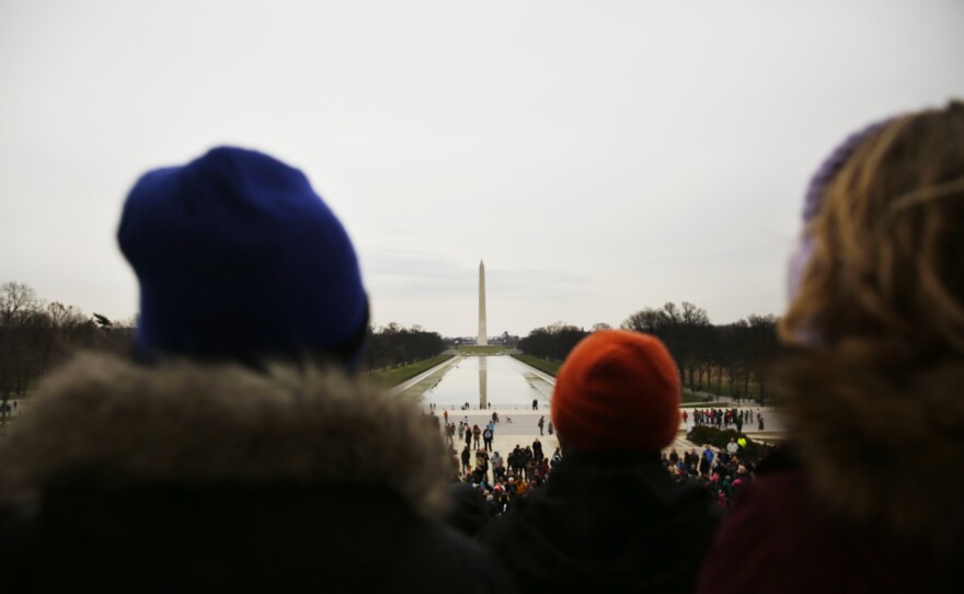 They look out over a crowd of class-mates, parents, tourists, and cameras, waiting to speak.