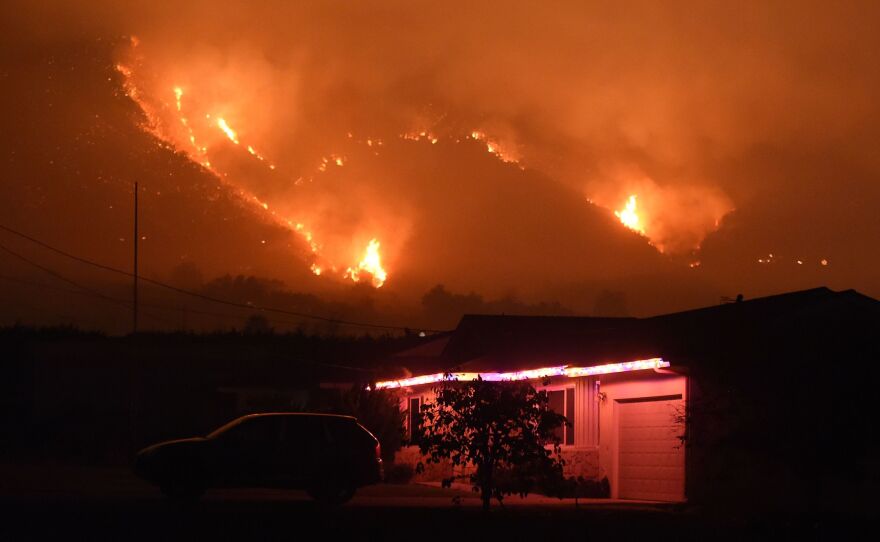 Flames from the Thomas Fire burn in the hills above Carpinteria, California, Dec. 11, 2017.