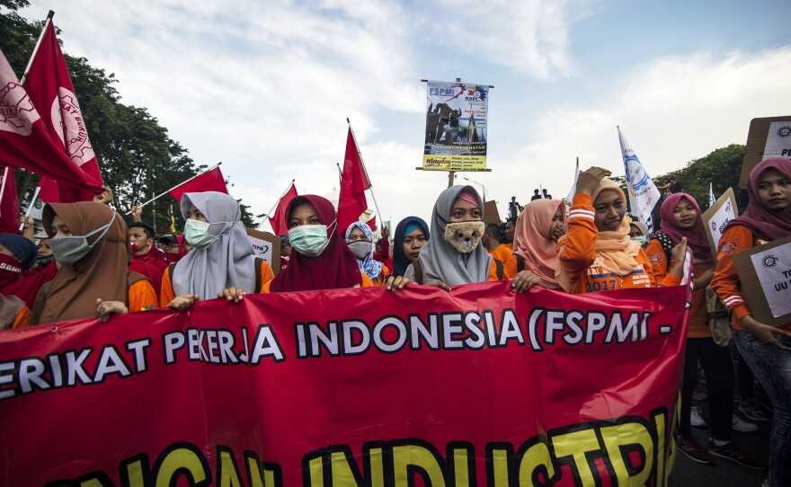 Indonesian demonstrators participate in a May Day protest in Surabaya. Millions of demonstrators took to the streets across the country to demand better social security, while rejecting outsourcing policies and low wages.