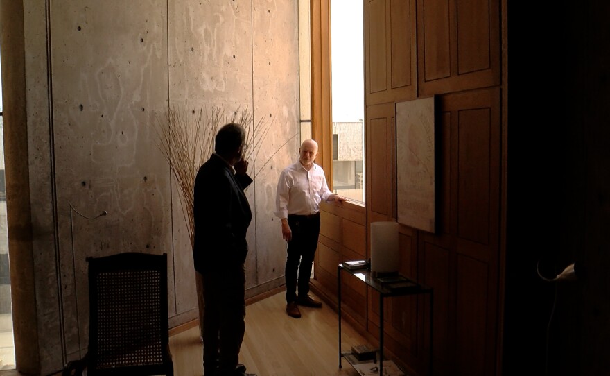 Salk Professor Greg Lemke stands near one of the famous teak panels in his personal study in the Salk Institute. June 1, 2022 