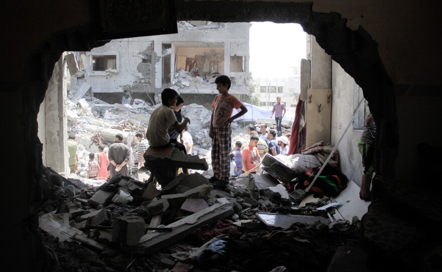 Palestinian boys at a damaged building in Rafah, the Gaza Strip, on Thursday. U.S. attempts to broker a comprehensive peace deal have again been shelved as Israel and Hamas have waged their third round of heavy fighting in Gaza in the past six years.