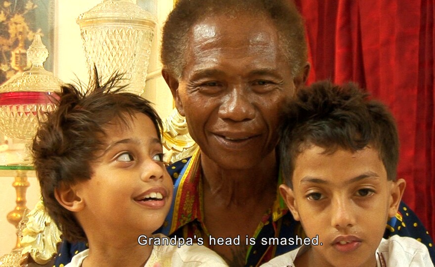 Death squad executioner Anwar Congo brings his grandsons in front of the TV to watch their grandpa play a torture victim in the documentary, "The Act of Killing." The Day Five recommendation in Cinema Junkie's 30 Days of Streaming Horror.