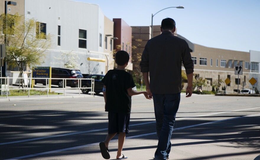 A father and his son walk outside of Rady Children's Hospital in San Diego, Feb. 9, 2016.