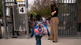 Kindergartener Angel Hernandez leaves after the first day of in-person learning at Maurice Sendak Elementary School in Los Angeles, Tuesday, April 13, 2021.