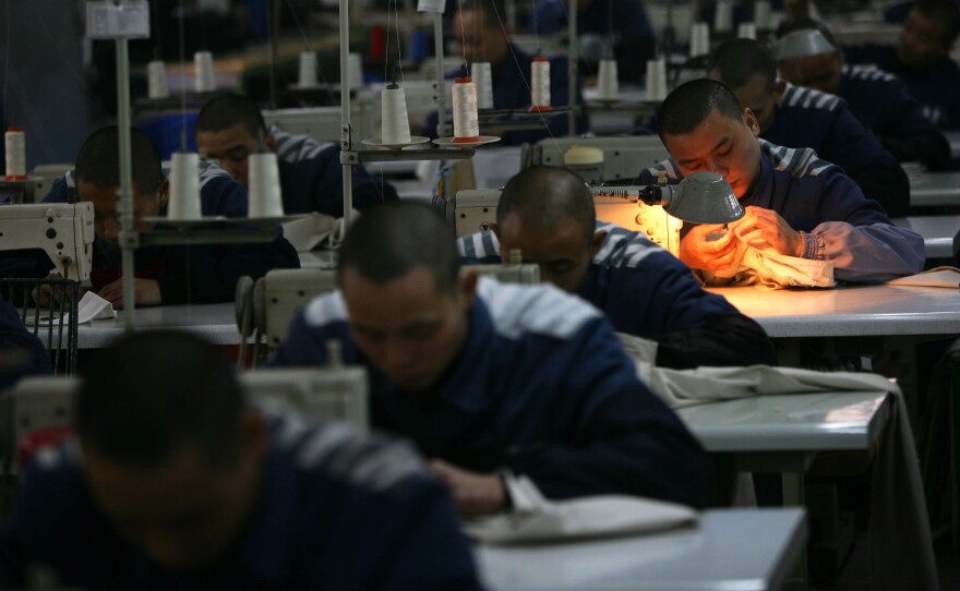 Inmates work on sewing machines at a prison in 2008 in Chongqing Municipality, China. said last year that it had halted programs of reeducation through labor camps.