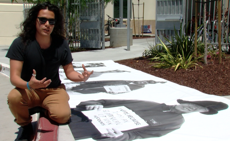 Photographer Rafael Rios discusses a mural he helped create, June 13, 2016.