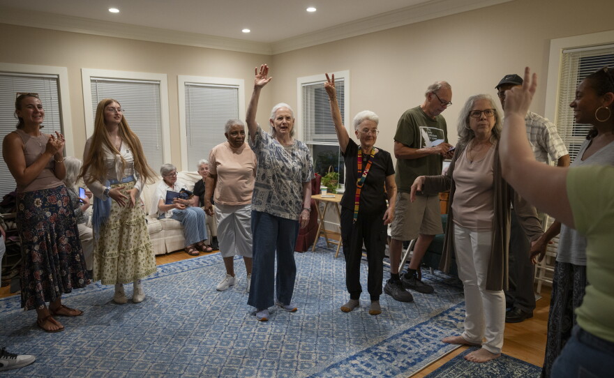 Former residents and friends of Anne Montgomery House prepare to dance a traditional Greek dance at the home's farewell celebration in Washington, D.C., on July 31, 2026.