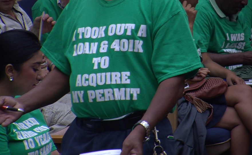 City Council chambers was a sea of green shirts Sept. 18, 2014. Cab company owners wore shirts saying "I took out a loan and 401K to acquire my permit" and "I worked hard for 10 years to earn my permit" to show their disapproval of a proposal to offer taxi permits to anyone who's driven cabs for five years and qualifies for an operators license.