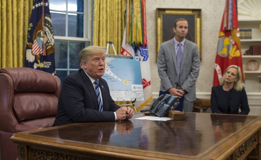 President Trump holds a briefing on Hurricane Florence in the Oval Office on Tuesday with FEMA Administrator Brock Long and Homeland Security Secretary Kirstjen Nielsen.