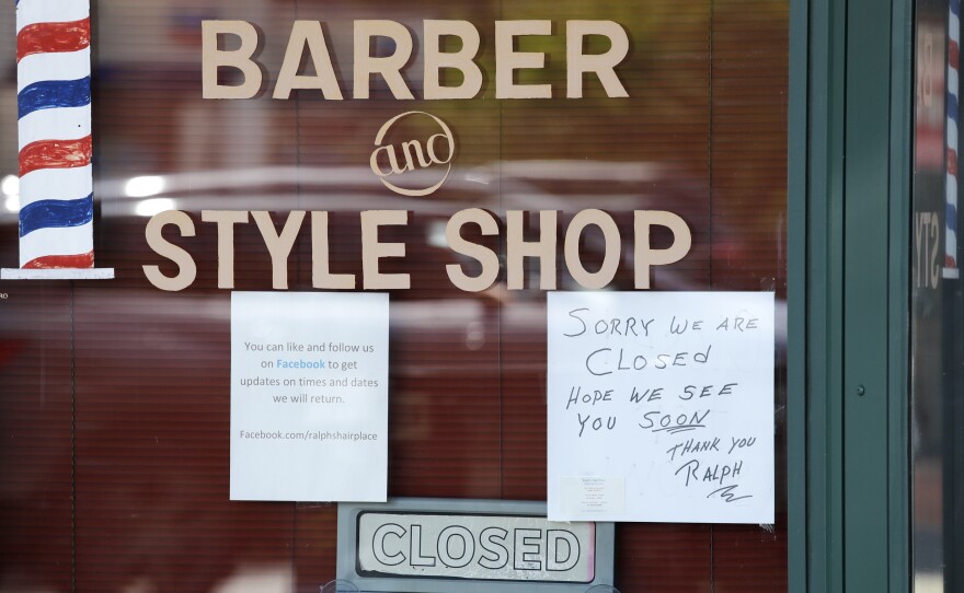 A Seattle barbershop remains closed because of the coronavirus outbreak on May 19. Last week, an additional 2.1 million people filed for unemployment benefits around the country.