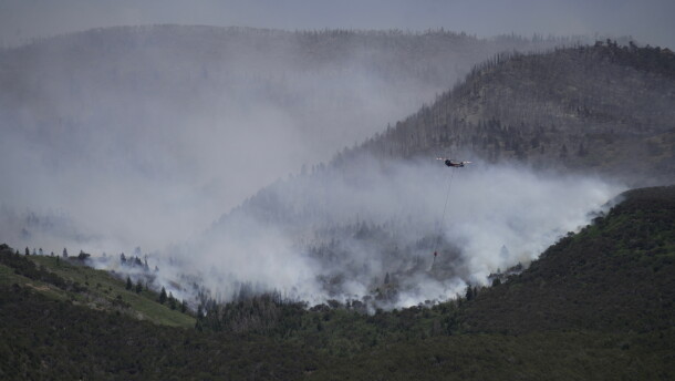 A helicopter drops water on the Cottonwood Fire in Beaver, Utah, on Saturday, June 27, 2026.