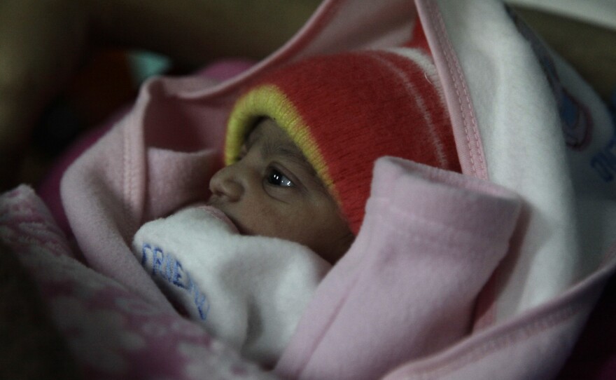 A 5-pound newborn girl is swaddled in a blanket in a hospital in Islamabad, Pakistan. She was born on Jan. 1, 2020.
