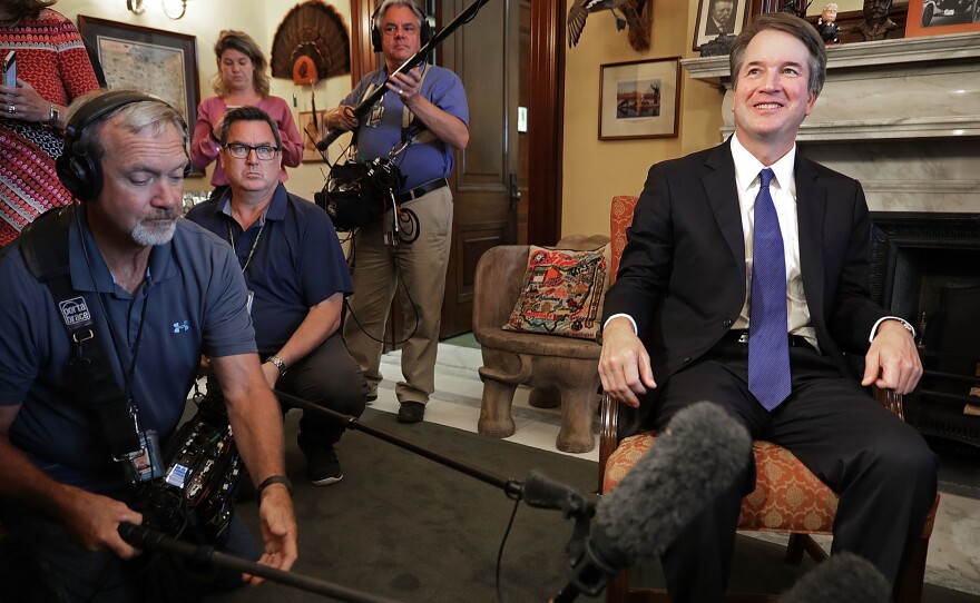 Judge Brett Kavanaugh listens to Sen. Rob Portman, R-Ohiom talk about Kavanaugh's qualifications before a meeting in the Russell Senate Office Building on Capitol Hill July 11, 2018 in Washington, D.C.