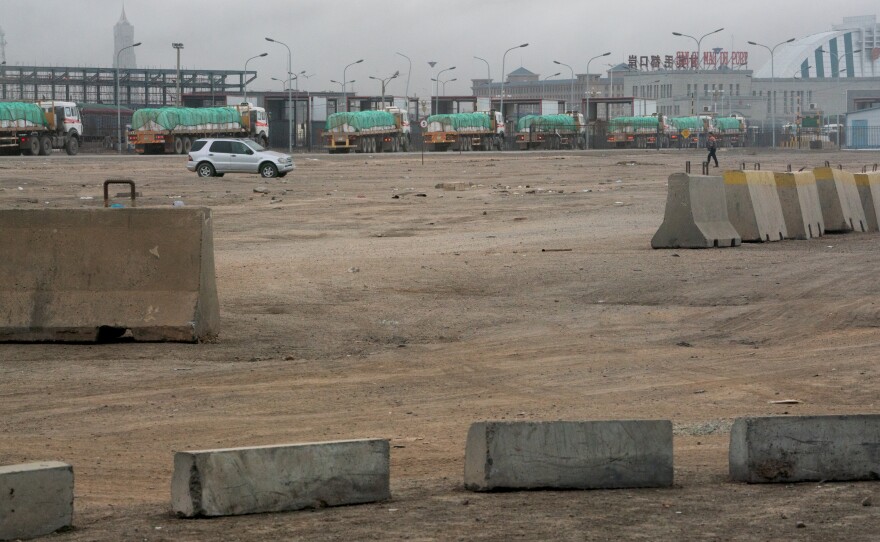 Approximately 1,100 vehicles cross the Mongolia-China border daily. These trucks carry copper concentrate from Oyu Tolgoi, packed in white bags and covered with a green tarp.