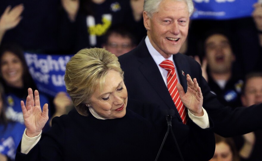 Democratic presidential candidate Hillary Clinton reacts as former President Bill Clinton smiles at a presidential primary campaign rally in Hooksett, N.H.