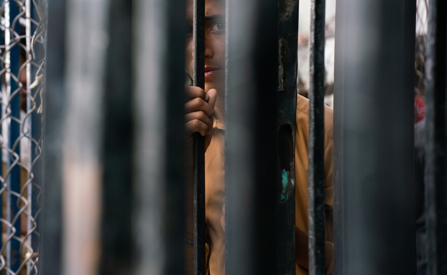 A boy on the Afghan side of the border awaits those returning to Afghanistan through Torkham.
