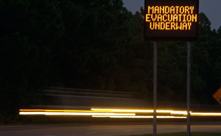 Cars stream past an evacuation message for Hatteras Island at the entrance to the Cape Hatteras National Seashore in Nags Head, N.C. A mandatory evacuation of visitors and residents is under way as Hurricane  Earl approaches.