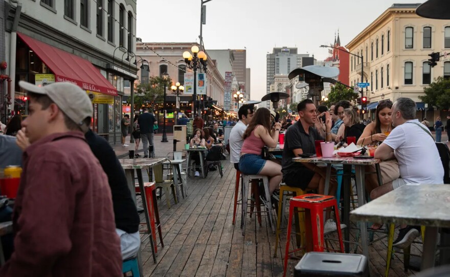 Customers in an outdoor seating area outside a restaurant in downtown San Diego on July 24, 2024.